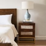 Handcrafted mango wood cane bedside table with rattan drawer fronts and gold metal base