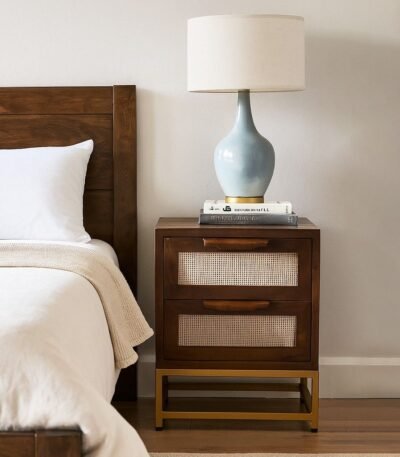 Handcrafted mango wood cane bedside table with rattan drawer fronts and gold metal base