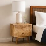 Handcrafted sheesham wood bedside table with hand-carved floral drawers and natural wood finish