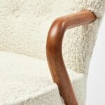 Armetta handcrafted sheesham wood boucle lounge chair with curved arms and cushioned seat