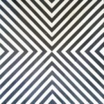 Geometric bone inlay black and white optical illusion side table with bold diamond pattern and hexagonal design.