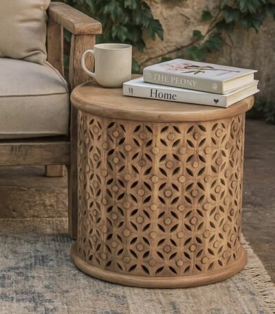 Hand-carved round wooden accent table featuring intricate floral lattice patterns