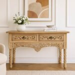 Handcrafted Sheesham wood console table with floral carvings and spiral legs in a natural light finish.