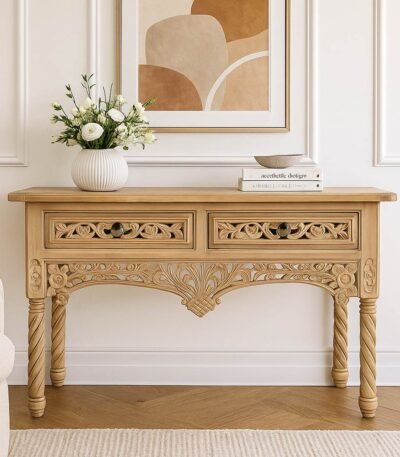 Handcrafted Sheesham wood console table with floral carvings and spiral legs in a natural light finish.