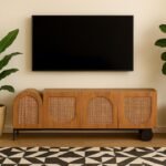 Vistaar mango wood rattan TV unit with asymmetrical cabinet doors and black metal accents by Wooden Slice