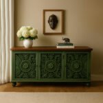 Distressed green mango wood console table with intricate hand-carved floral motifs and brown wooden top.