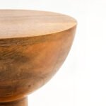 Handcrafted round solid wood side table with natural finish and sculptural hourglass base.