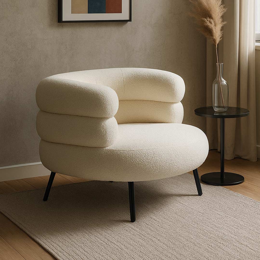 Bouclé Upholstered Armchair – Restique by Wooden Slice Modern bouclé upholstered armchair with a rounded silhouette and black metal legs.