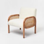 Handcrafted solid wood cane chair with curved Sheesham wood frame, natural cane sides, and plush bouclé cushions.