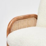 Handcrafted solid wood cane chair with curved Sheesham wood frame, natural cane sides, and plush bouclé cushions.