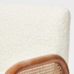 Handcrafted solid wood cane chair with curved Sheesham wood frame, natural cane sides, and plush bouclé cushions.