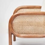 Handcrafted solid wood cane chair with curved Sheesham wood frame, natural cane sides, and plush bouclé cushions.