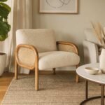 Handcrafted solid wood cane chair with curved Sheesham wood frame, natural cane sides, and plush bouclé cushions.