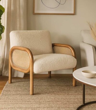 Handcrafted solid wood cane chair with curved Sheesham wood frame, natural cane sides, and plush bouclé cushions.