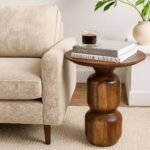 Sculpted wooden accent side table with smooth round top and stacked pedestal base in natural Sheesham wood finish.