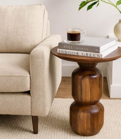 Sculpted wooden accent side table with smooth round top and stacked pedestal base in natural Sheesham wood finish.