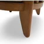 Handcrafted solid wood lounge chair with artistic backrest and circular cushioned seat in cream upholstery – luxury designer accent chair