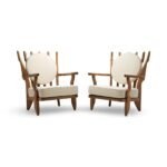 Handcrafted solid wood lounge chair with artistic backrest and circular cushioned seat in cream upholstery – luxury designer accent chair