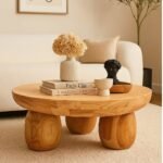 Orvian handcrafted round solid wood coffee table with sculpted legs