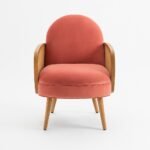 Handcrafted solid wood rattan armchair with coral cushioned seat