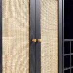 NoirCane Sheesham wood bar cabinet with black finish and natural cane doors, wine rack, display shelf, and mid-century legs.