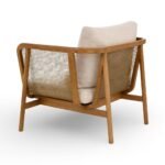 Rattan armchair with solid wood frame, cane sides and beige upholstered cushion