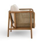 Rattan armchair with solid wood frame, cane sides and beige upholstered cushion