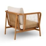 Rattan armchair with solid wood frame, cane sides and beige upholstered cushion