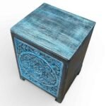 Solid wood handcarved bedside table crafted from mango wood featuring floral carving and distressed blue finish