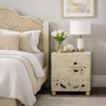 Handcarved bedside table made from solid mango wood featuring detailed floral carvings and three storage drawers