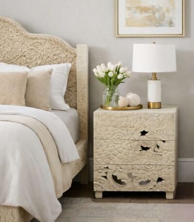 Handcarved bedside table made from solid mango wood featuring detailed floral carvings and three storage drawers