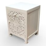 Carved bedside table handcrafted from solid mango wood with floral detailing and white polished finish