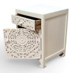 Carved bedside table handcrafted from solid mango wood with floral detailing and white polished finish