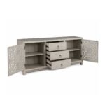 Hand carved TV unit in distressed beige finish crafted from solid mango wood with floral carved cabinet doors and storage drawers.
