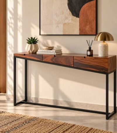 Sheesham Wood Console Table with three walnut brown wooden drawers, recessed handles and slim black iron legs.