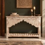 Hand Carved Mango Wood Console Table with Rajasthani floral arch detailing, slatted lower shelf and distressed natural wood finish.