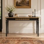 Black and Gold Console Table with floral medallions, fluted apron and traditional turned pillar legs in matte black finish.
