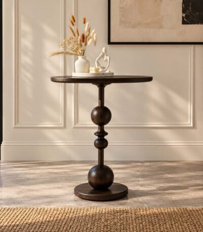 Solid Wood Accent Table with round tabletop, sculptural stacked sphere pedestal and circular wooden base.