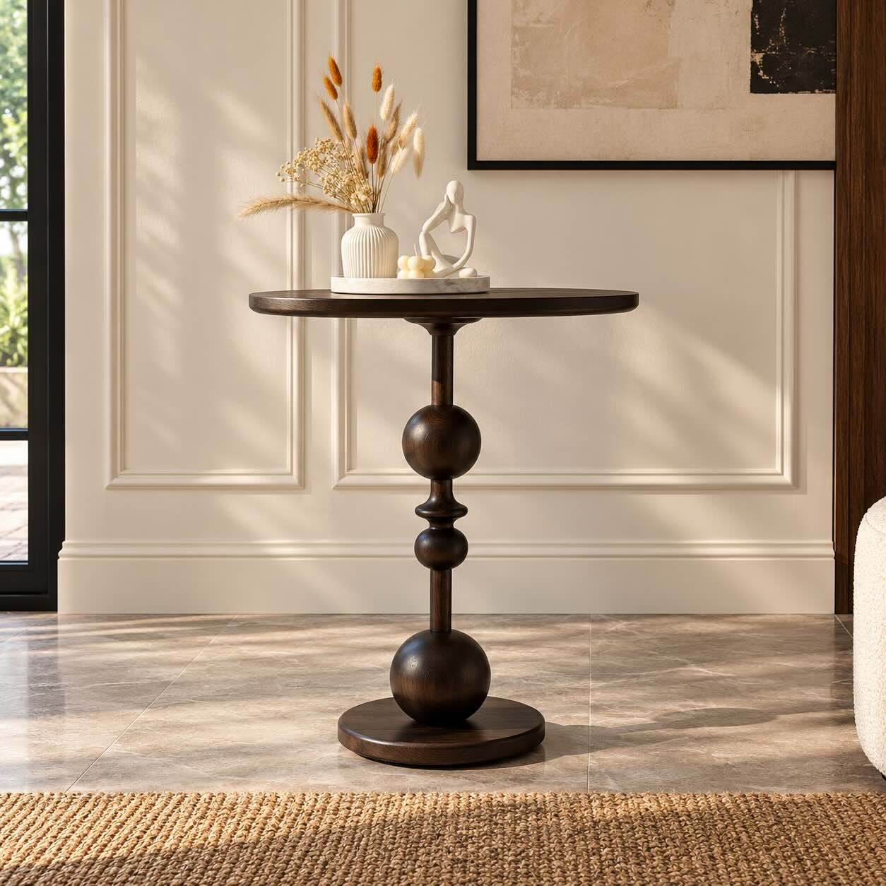Spherelle Solid Wood Round Accent Table with Sculptural Sphere Pedestal Solid Wood Accent Table with round tabletop, sculptural stacked sphere pedestal and circular wooden base.