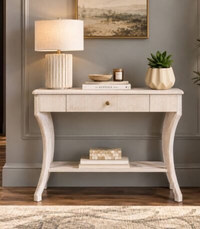Whitewash Wooden Console Table with fluted storage drawer, curved wooden legs and open lower shelf in distressed white finish.