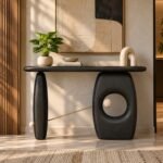 Mango Wood Console Table with sculptural oval pedestals, circular cutout and brass accents in charcoal black finish.