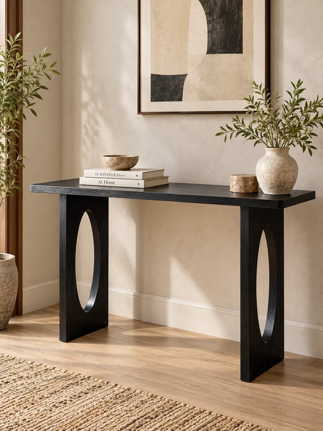 Zarvello Sheesham Wood Console Table with Oval Cut-Out Legs in Black Finish Sheesham Wood Console Table with sculptural oval cut-out legs in black finish.