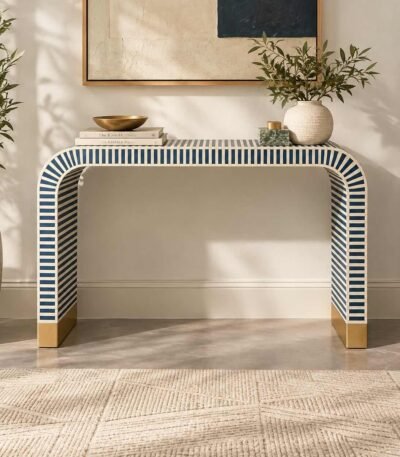 Bone Inlay Console Table with navy blue and ivory striped pattern, curved waterfall legs and gold-toned base accents.