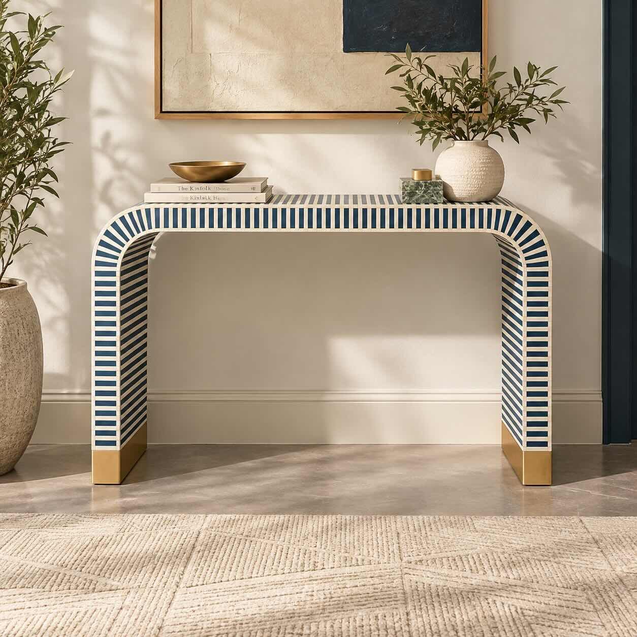 Azulith Bone Inlay Console Table with Navy Blue and Ivory Striped Waterfall Design Bone Inlay Console Table with navy blue and ivory striped pattern, curved waterfall legs and gold-toned base accents.