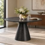 Conetra Black Mango Wood Dining Table with 50-inch round tabletop, sculptural conical pedestal base and black stained finish.