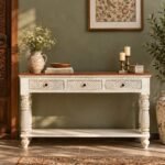Carved Wooden Console Table with three decorative drawers, turned wooden legs and an open shelf in distressed white and natural wood finish.
