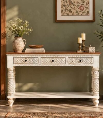 Carved Wooden Console Table with three decorative drawers, turned wooden legs and an open shelf in distressed white and natural wood finish.