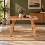 Elmbrook acacia wood splayed leg dining table with natural finish, rounded rectangular tabletop and outward-angled solid wooden legs.