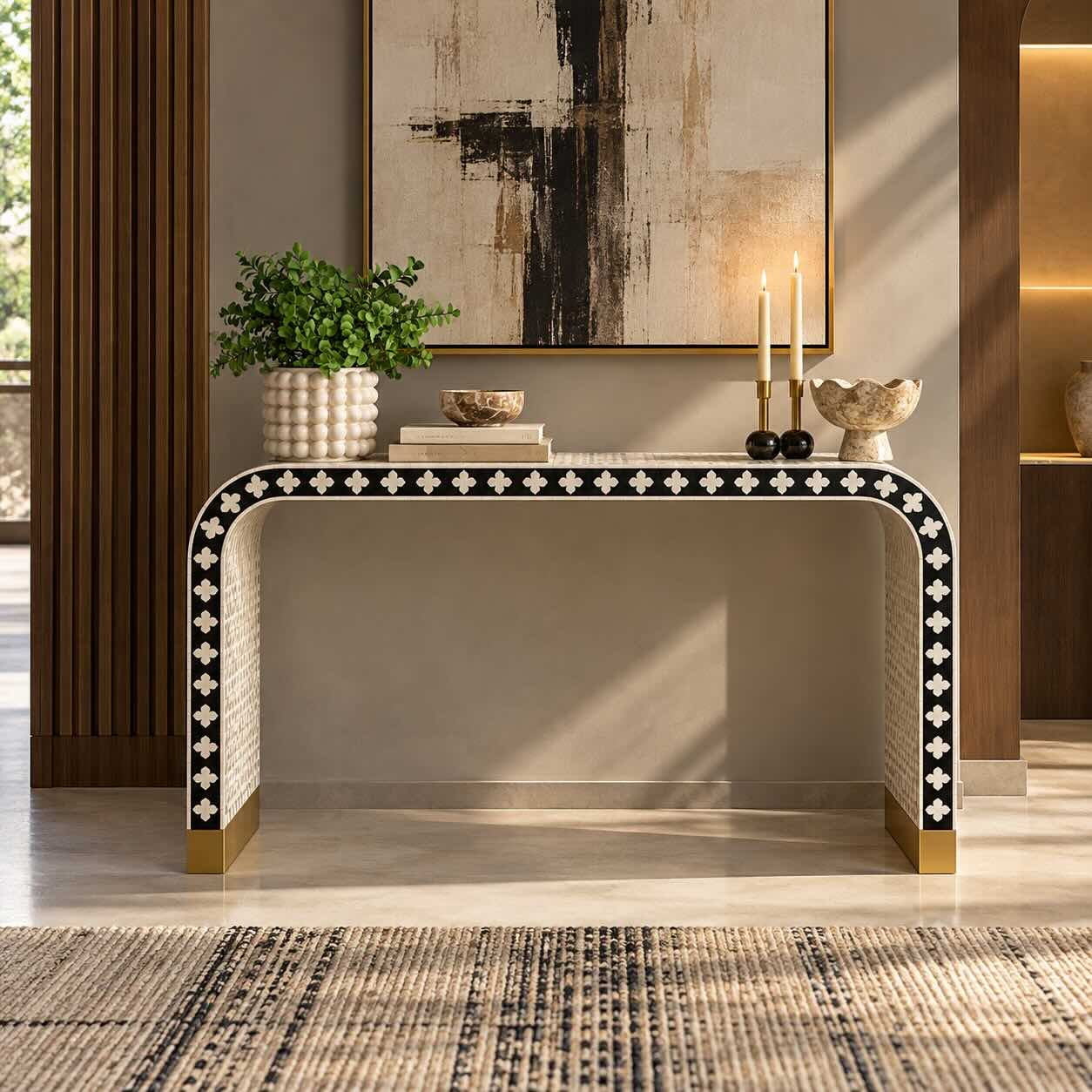 Floravique Bone Inlay Console Table with Ivory Floral Motifs and Black Waterfall Design Bone Inlay Console Table with black finish, ivory floral motifs, curved waterfall legs and gold-toned base accents.