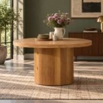 Oakmere solid wood round pedestal dining table with 60-inch circular tabletop, cylindrical wooden base and natural finish.